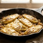 découvrez notre recette savoureuse et réconfortante de délice d’endives braisées nappées d’une onctueuse crème de maroilles, un plat gourmand qui ravira vos papilles.
